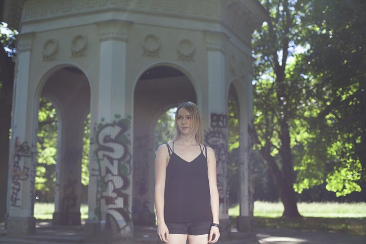 Portrait of a woman in a sunlit park